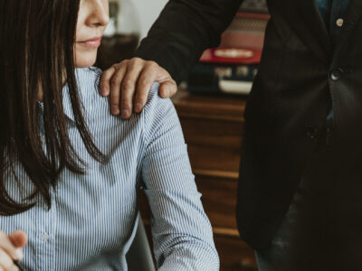 Businessman patting a colleague on her shoulder